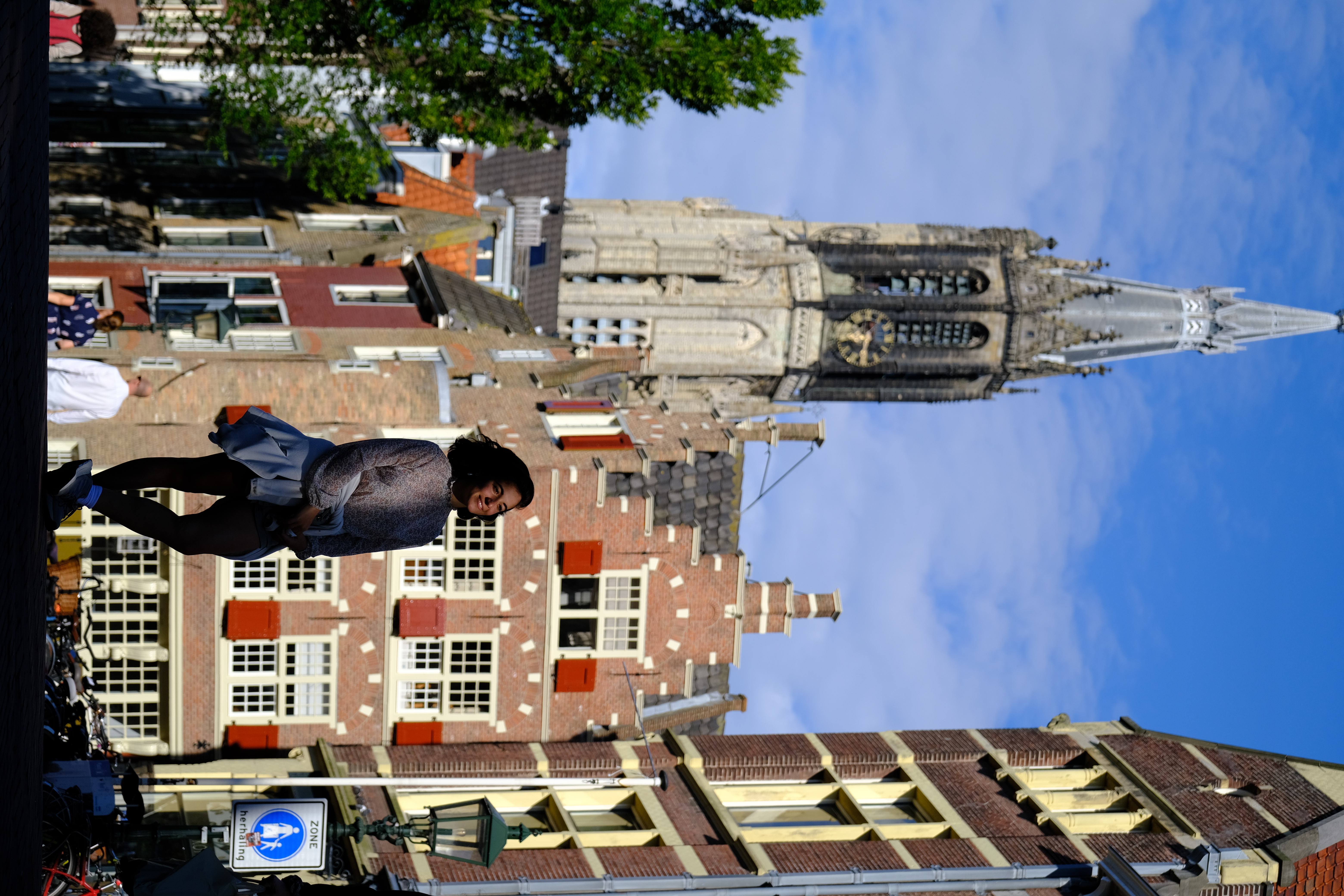 Full-figure lifestyle moment with church tower backdrop, Delft 2024